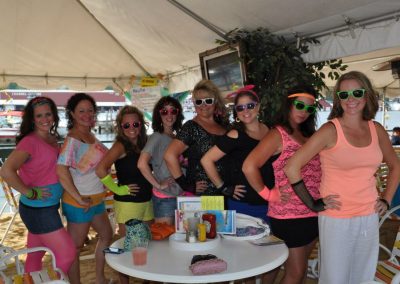 Group of women posing at a tent