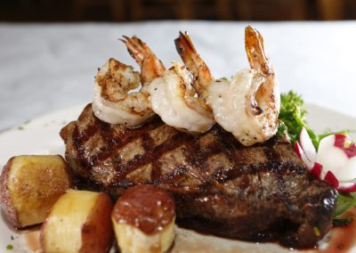 Steak, shrimp and potatoes.