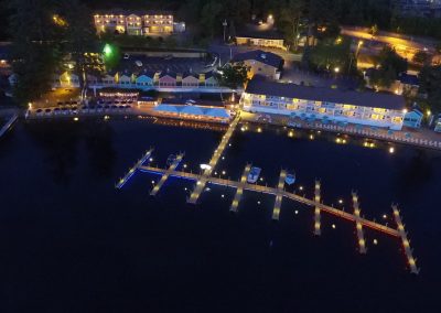 Aerial view of The NASWA Resort, docks and Lake Winnipesaukee at night