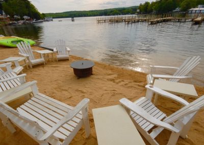 Adirondack chairs around a fire pit.