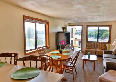 Paugus Suite breakfast bar, dining table and living room.