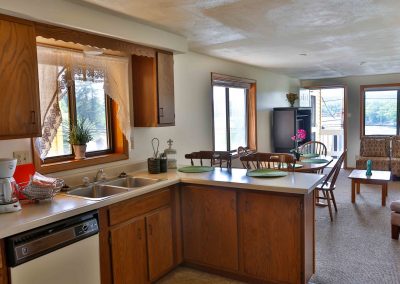 Paugus Suite kitchen, dining table and living room.