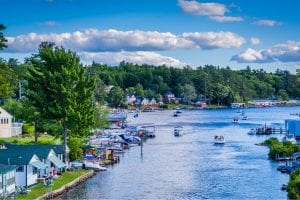 A collection of boats hangs out in Paugus Bay, one of the many things to do in Laconia, NH, in the summer.