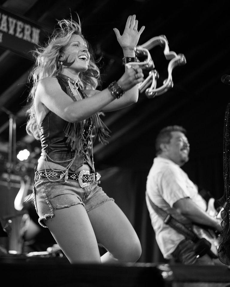 Jodi Cunningham playing a bird shaped tamborine.
